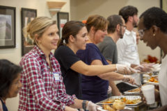 Assembly line of 6 people serving food to people