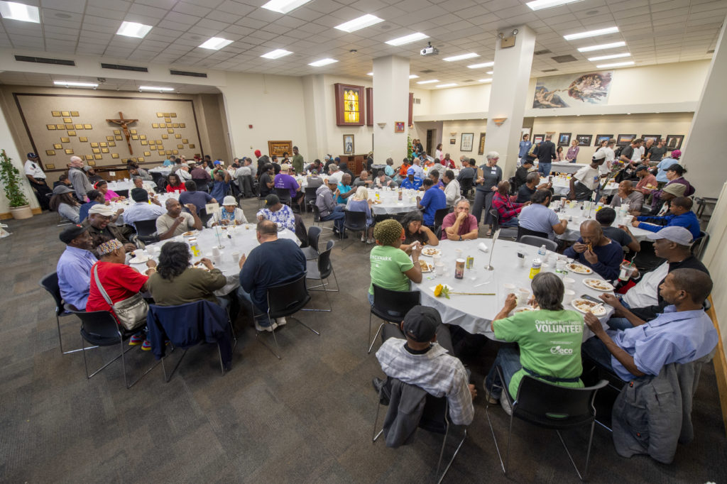 Gathering of people sitting at round tables