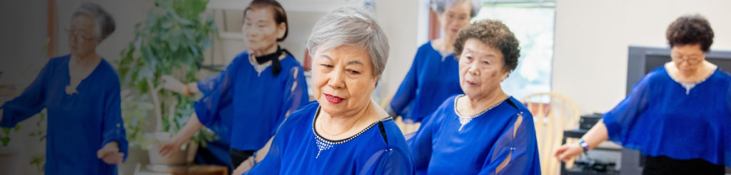 A group of people in matching outfits and doing synchronized movement