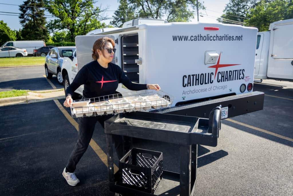 Meals on Wheels Delivery volunteer loading meals onto cart