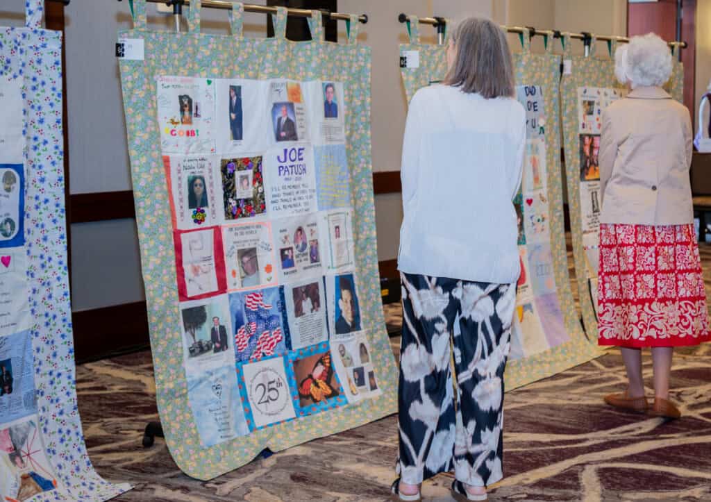 Women looking at quilts at Blossoms of Hope Brunch 2026