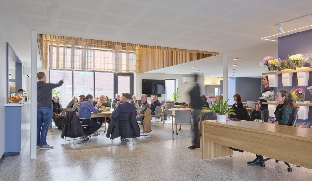 The first floor of the new Community Center includes a food pantry, a central gathering room where coffee, snacks, and hot meals are served, an industrial kitchen, and a basic-needs distribution room. 