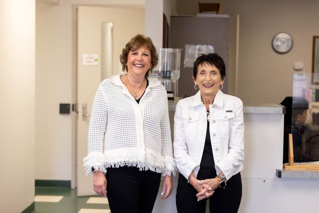 For years, Kathy Brosmith and Paulette Van Erden have volunteered at the Bernardin Center, greeting every person who enters the building.