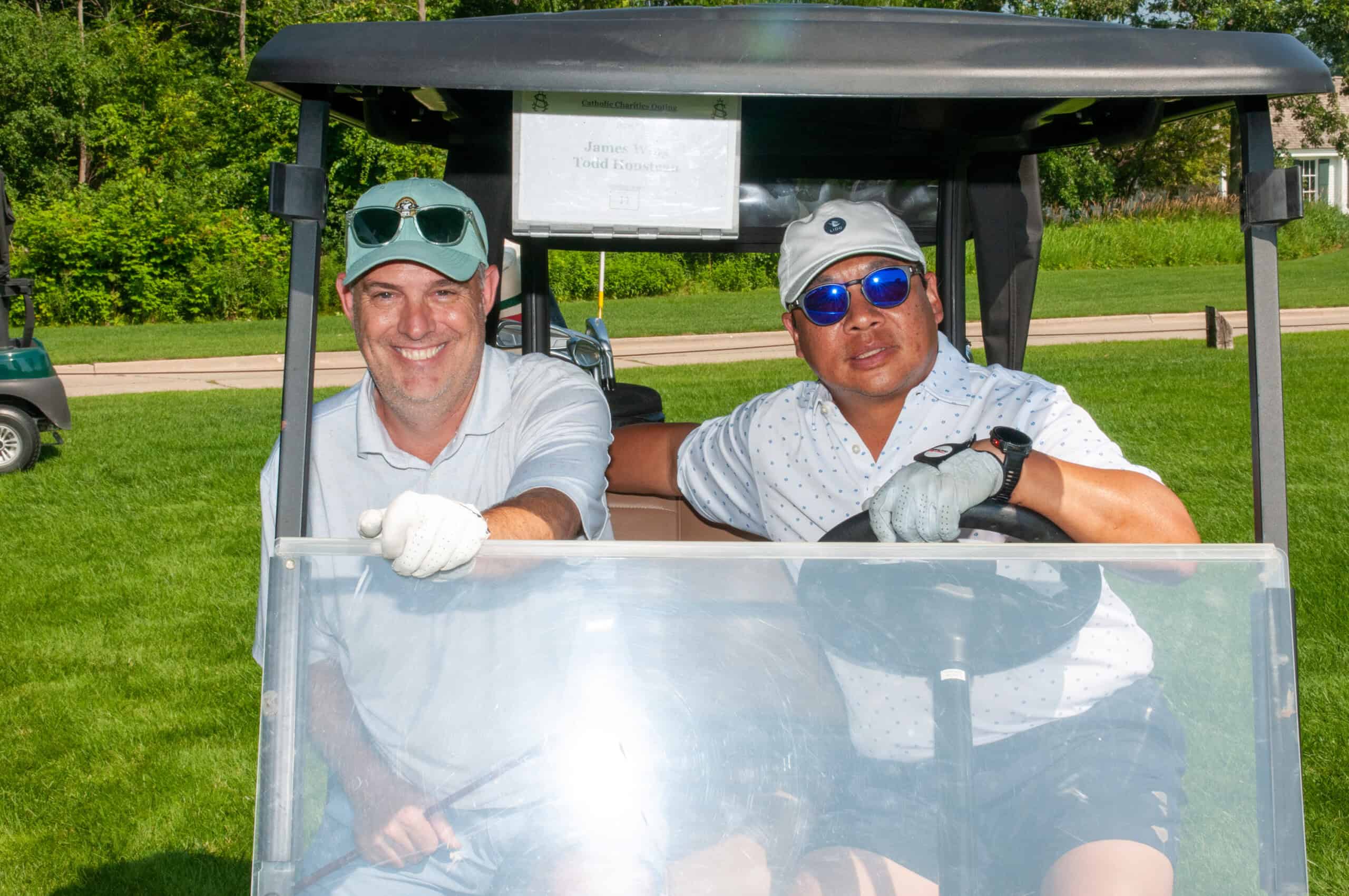 Golf classic golfers riding in a golf cart