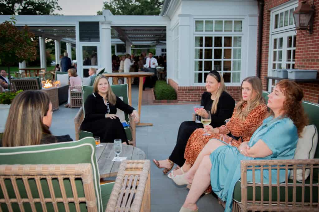 5 women socializing outside at Art of Caring fundraiser