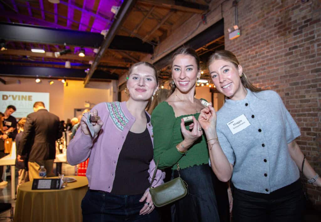 Group Photo of women holding wine corks at 2026 D'Vine Affair