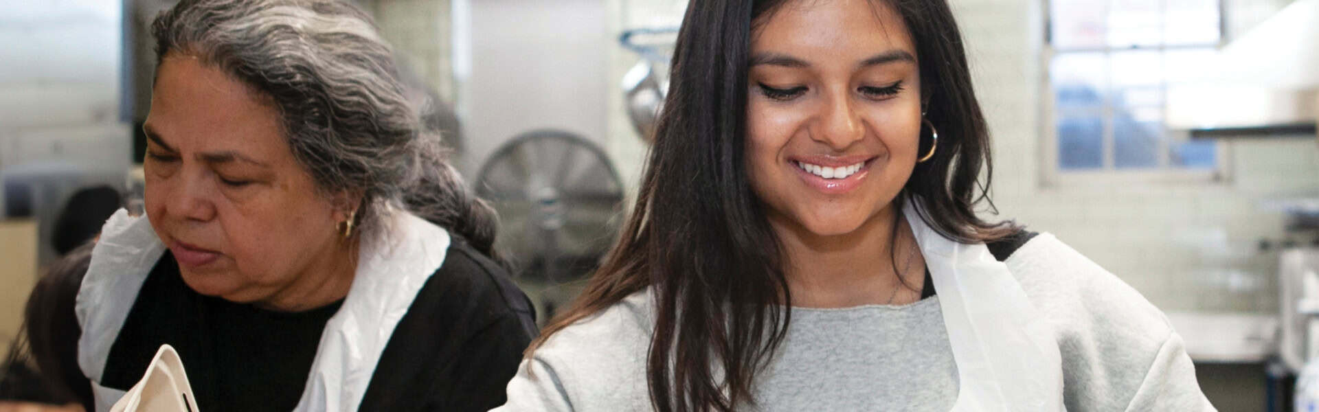 Two volunteers preparing food