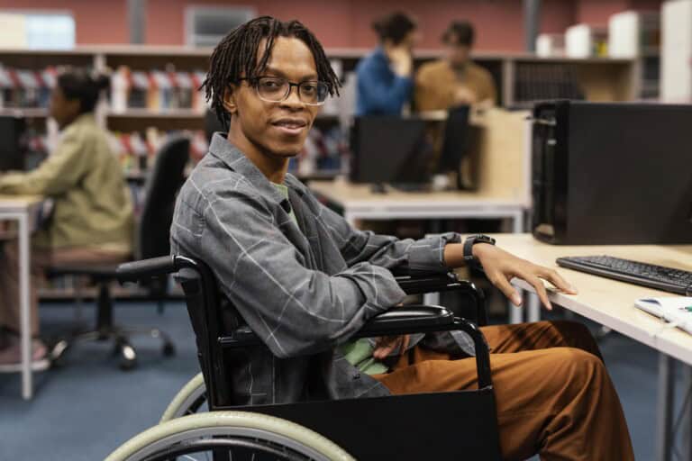 Man in a wheelchair using a computer