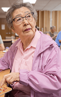Senior playing bingo at Frances Manor